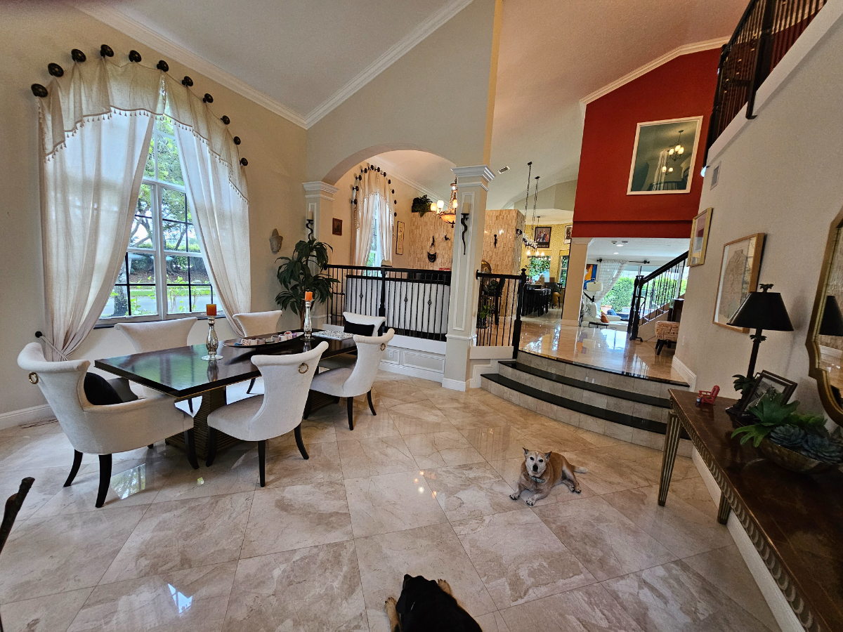 Deep-cleaned living and dining room with polished marble floors, Wellington FL