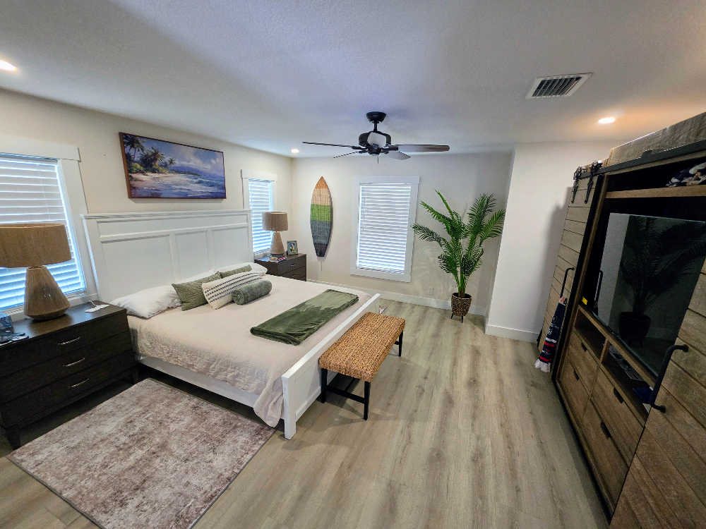 Freshly cleaned master bedroom with made bed and tidy floors, West Palm Beach FL